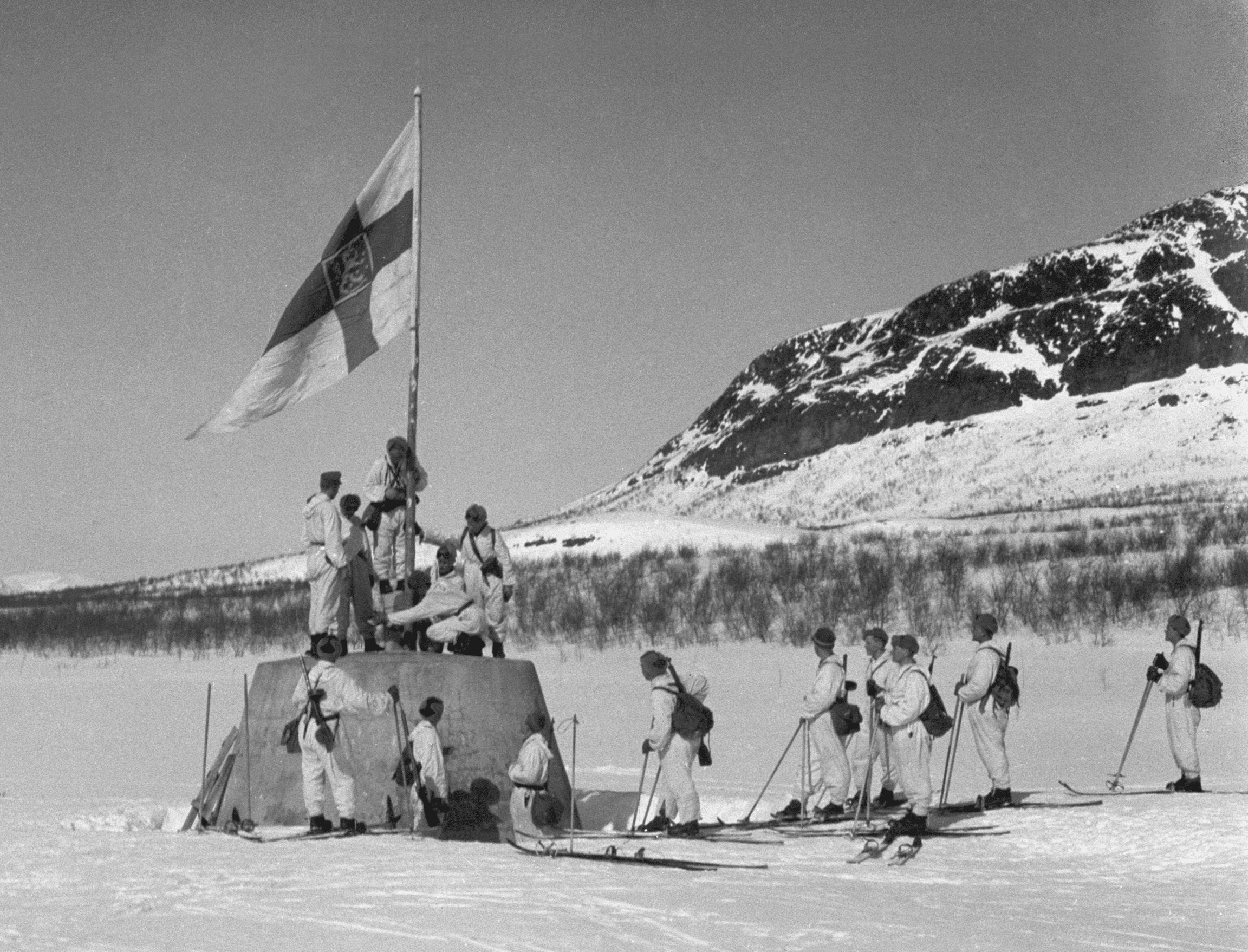 Raising the Flag on the Three-Country Cairn Logo